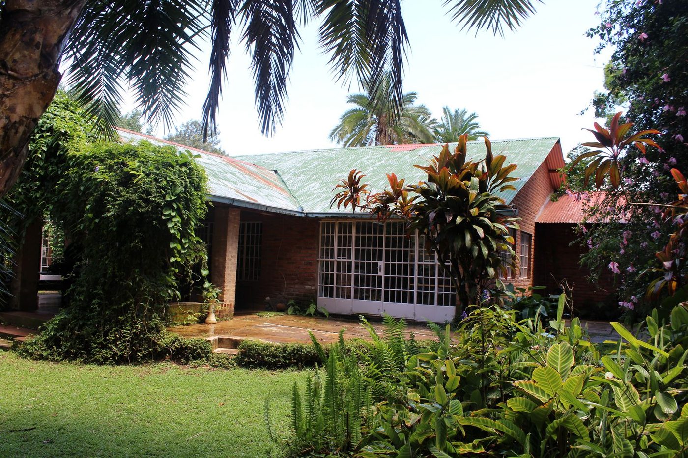 Main house exterior with brick walls, vines, and colonial architecture