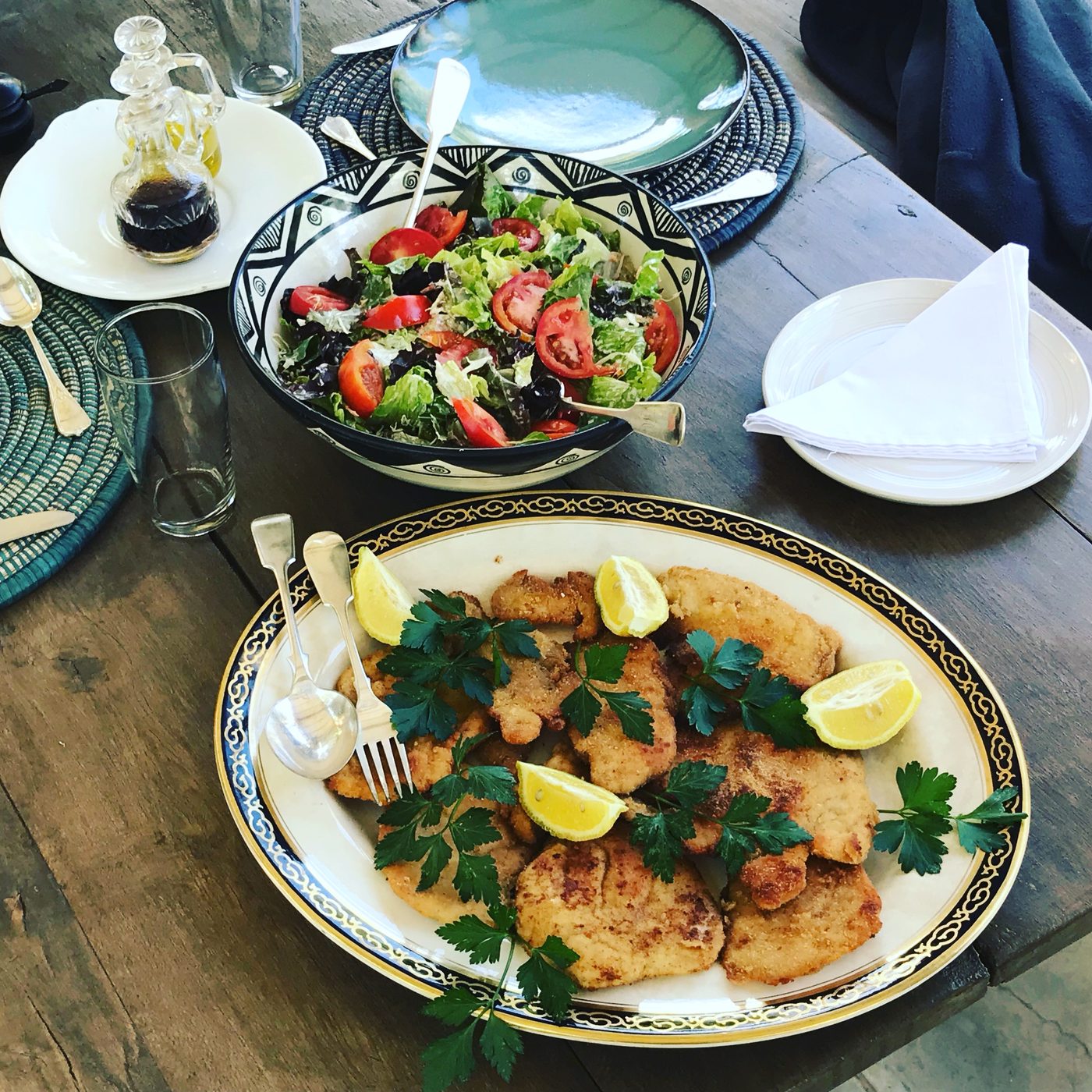 Cotoletta milanese and garden salad viewed from above